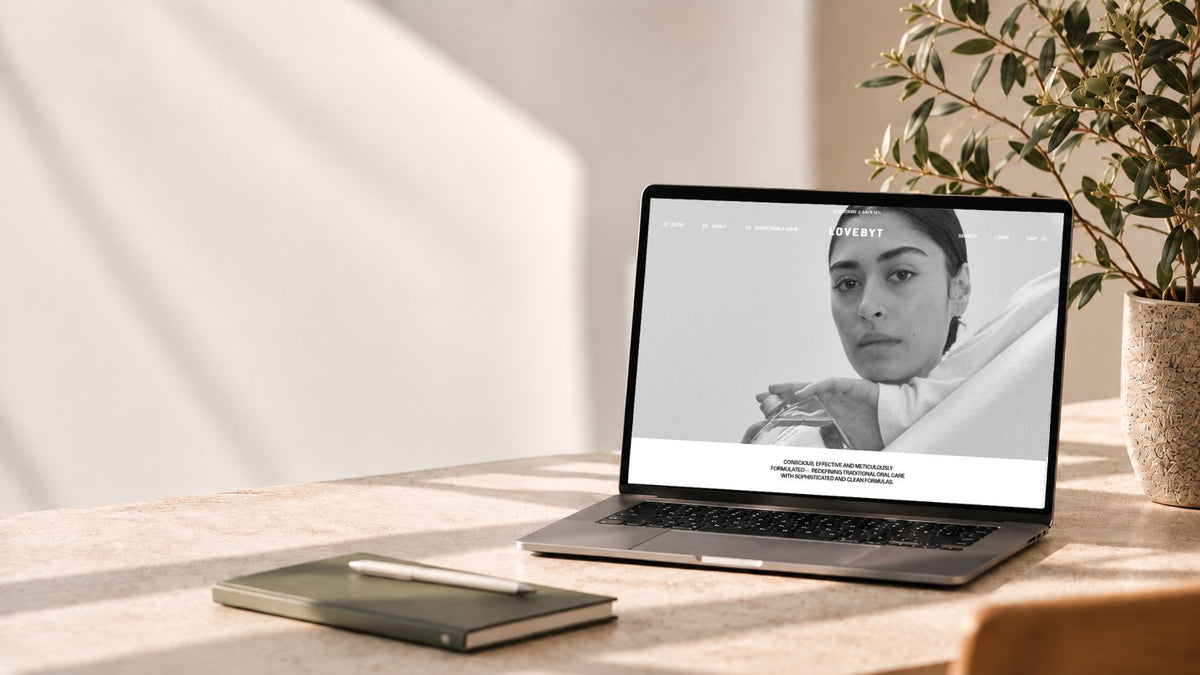 Laptop displaying the Lovebyt e-commerce website on a desk