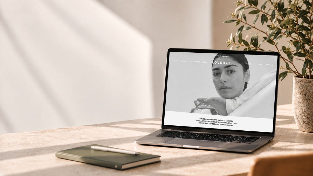 Laptop displaying the Lovebyt e-commerce website on a desk